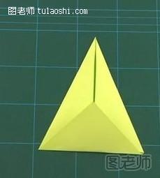 步骤1:将纸张摆成菱形，依上顶点两侧向内对折，然后下面的三角形向上对折