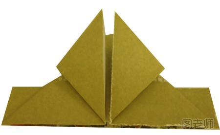 步骤7:现在先用其中一面做示范，先将两边的三角形对着最上面的角折上去