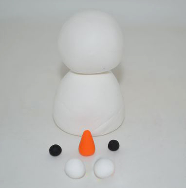 STEP3：再搓两个黑色小圆，两个白色圆球，一个橘黄色长水滴，分别作为双眼、小手和鼻子。